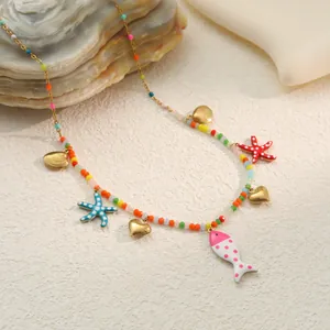 Detailed view of the ocean-themed necklace featuring sea star, fish, and heart charms