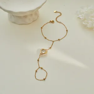 Elegant heart-shaped clear zircon gold-plated hand chain bracelet with delicate bead accents.