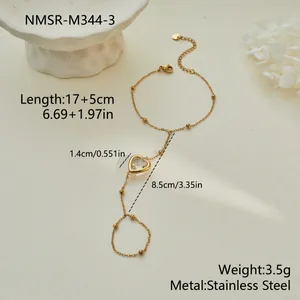 Detailed view of gold hand chain bracelet with heart crystal showing all product measurements