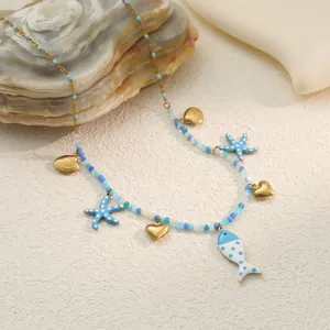 Close-up detail of summer ocean element necklace featuring fish and starfish charms