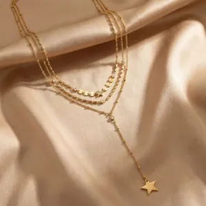 Detail showing the texture of a triple-layered gold stainless steel star necklace.