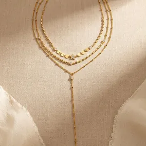 Detailed macro view of gold-plated stainless steel layered necklace with star pendant