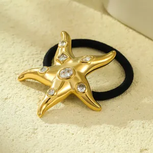 Close-up of a 18k gold plated stainless steel starfish hair tie featuring sparkling crystals.