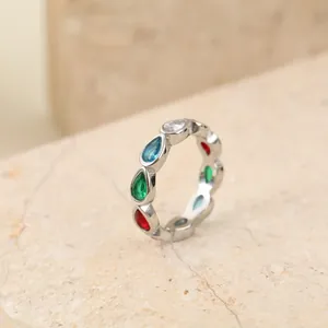 Close-up of a silver stainless steel ring set with colorful pear-shaped gemstones