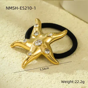 Detailed view of an 18k gold plated stainless steel starfish hair tie with crystal inlay