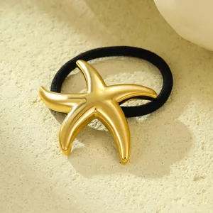 Detail shot of a golden starfish hair tie featuring a polished stainless steel finish