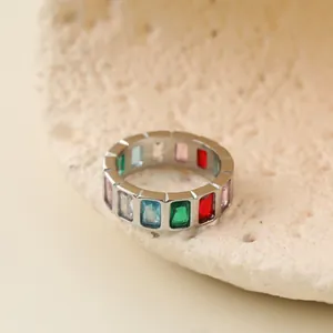 Detailed macro view of a colorful baguette-cut gemstone eternity ring in steel.