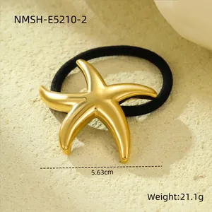 Detailed macro shot of an 18k gold plated stainless steel starfish metal hair tie