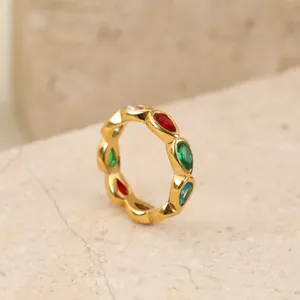 Detail view of a gold stainless steel ring featuring colorful marquise gemstones