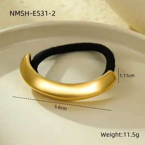 Close-up detail of golden curved stainless steel hair tie with size and weight specs