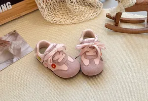 Detailed close-up showing pink girls' casual sneakers with embroidered flower accents and soft sole.