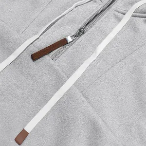 Primer plano del detalle de la cremallera y la textura de vellón de una sudadera gris