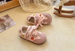 Detailed view of pink girls' German training shoes featuring cute 3D floral embroidery