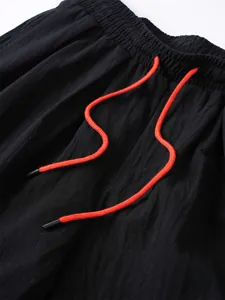 Detalle de pantalón de algodón y lino con cordón naranja y cintura elástica.