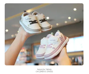 Close-up detail of two pairs of breathable toddler walking shoes in beige and pink