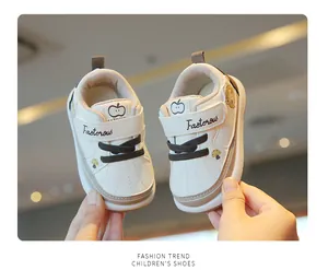 Detail of cream baby walking shoes featuring soft soles and cute apple patterns for toddlers