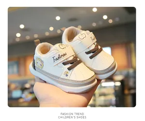 Close-up of cream toddler walking shoes with cute lion cartoon and velcro strap detail