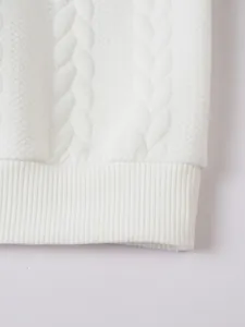 Detailed macro view of white cable knit texture and ribbed hem on men's winter sweater