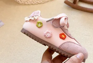 Detailed side view of pink toddler GAT shoes with cute embroidered floral patterns