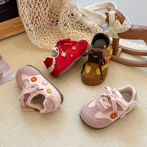 Detailed view of breathable mesh girls' sneakers with floral embroidery and soft soles