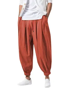 Vista frontal de pantalones harem de hombre en algodón y lino naranja con cordón