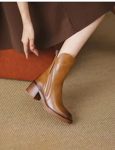 Detailed view of brown vintage ankle boots with side zipper and chunky block heel