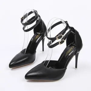Elegant black pointed-toe high heels with double ankle straps and stiletto heels.