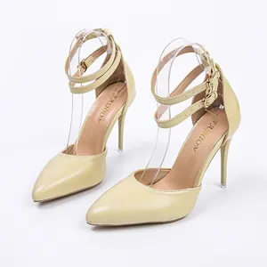 Detailed view of pointed-toe stiletto sandals with double ankle straps and gold buckles.