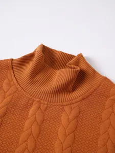 Detailed close-up of a men's high-neck knit sweater featuring cable and honeycomb patterns.