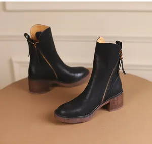 Elegant black leather ankle boots with chunky wood-grain heel and side zipper detail