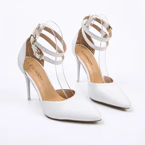 Elegant white pointed-toe stilettos with double ankle straps and gold buckles.