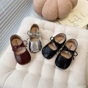 Detailed view of French-style girls' Mary Jane flats in silver, burgundy, and black colors.