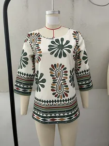 Detailed view of the vibrant ethnic floral pattern on this round neck 3/4 sleeve top