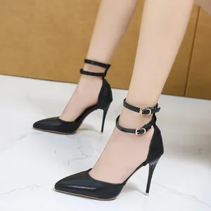 Elegant black leather pointed-toe stiletto pumps with double gold-buckle ankle straps