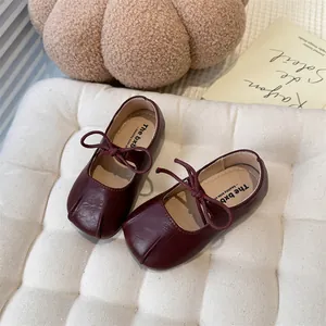 Detailed view of deep burgundy French-style Mary Jane shoes for girls with elegant bow knot.