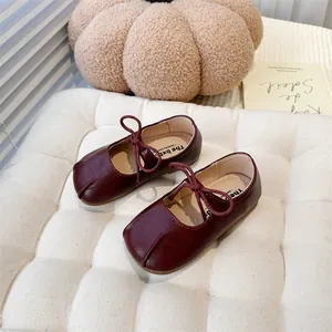 Detailed view of burgundy Mary Jane shoes for girls featuring a cute bow and square toe