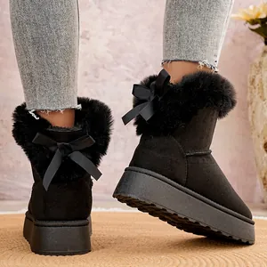 Vista detallada de las botas de nieve de ante negro con plataforma y lazo trasero