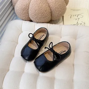 High-quality close-up of black French Mary Jane toddler shoes with soft soles and knot details