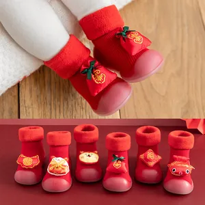 Festive red baby sock shoes with warm fleece lining and non-slip soles for New Year.