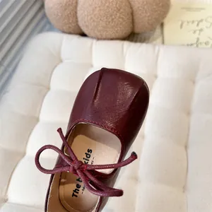 Detailed view of burgundy French style Mary Jane shoes for girls with bow detail