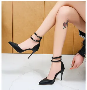 Side view of black stiletto high heels with elegant ankle straps and pointed toe