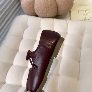 Side profile detail of girls' dark red leather Mary Jane flat shoes with soft gum sole