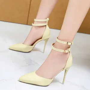 Elegant pale yellow pointed-toe high heels with double ankle straps for women.