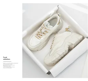 Detail view of stylish women's thick sole white chunky dad sneakers in a white box