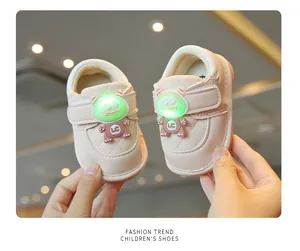 Close-up of pink baby walking shoes with glowing green monster LED light