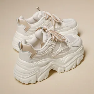 Stylish cream chunky platform sneakers for women with thick soles and woven laces design.