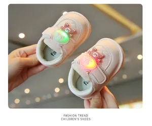 Close-up view of pink toddler light-up squeaky shoes with glowing cartoon characters