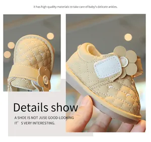 Detailed view of beige baby walking shoes featuring quilted leather and a cute floral design.
