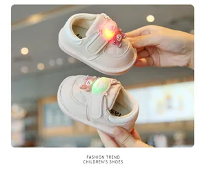 Detailed view of pink light-up baby walking shoes with soft soles for infants.
