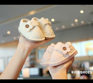 Detailed view of quilted baby walking shoes with decorative flower and soft sole.